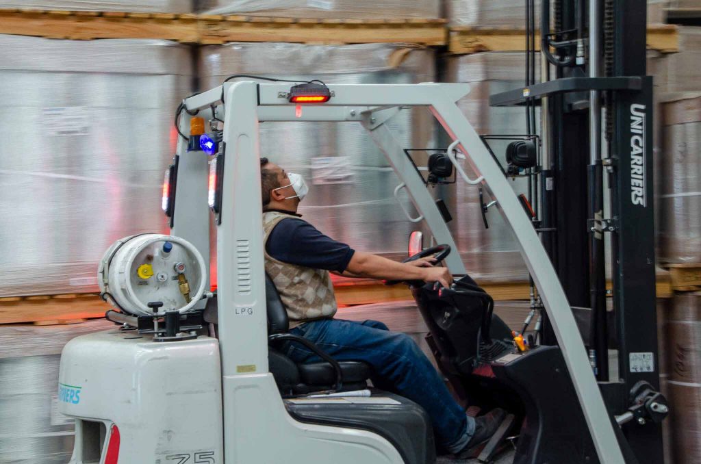 Worker driving a loading cart